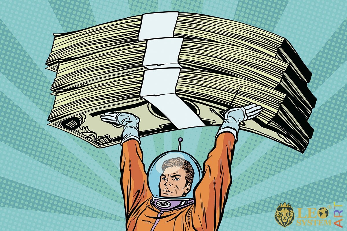 The cosmonaut holds bundles of money over his head