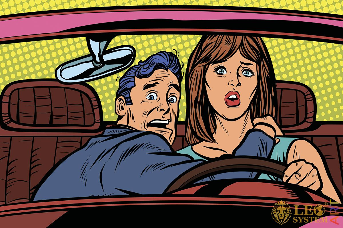 Picture of a frightened man with a woman driving a car