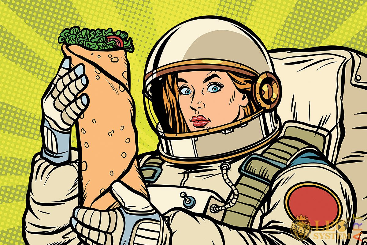 Woman dressed as an astronaut with a big sandwich in her hands