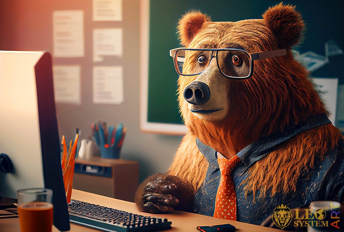 Surprised bear sits at the monitor screen